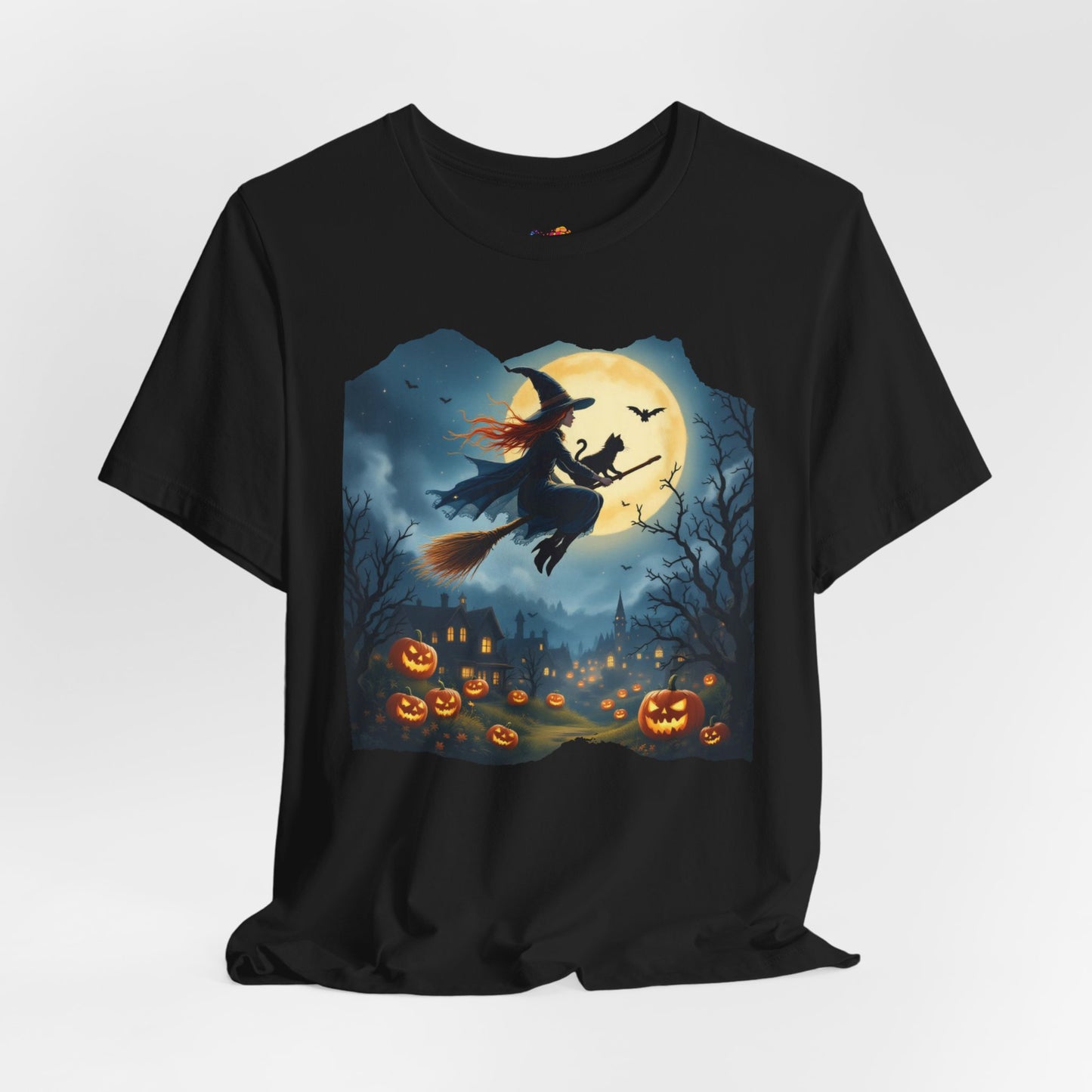 Midnight Flight Tee Magic in the sky. Pumpkins below. Cozy spells in every thread.